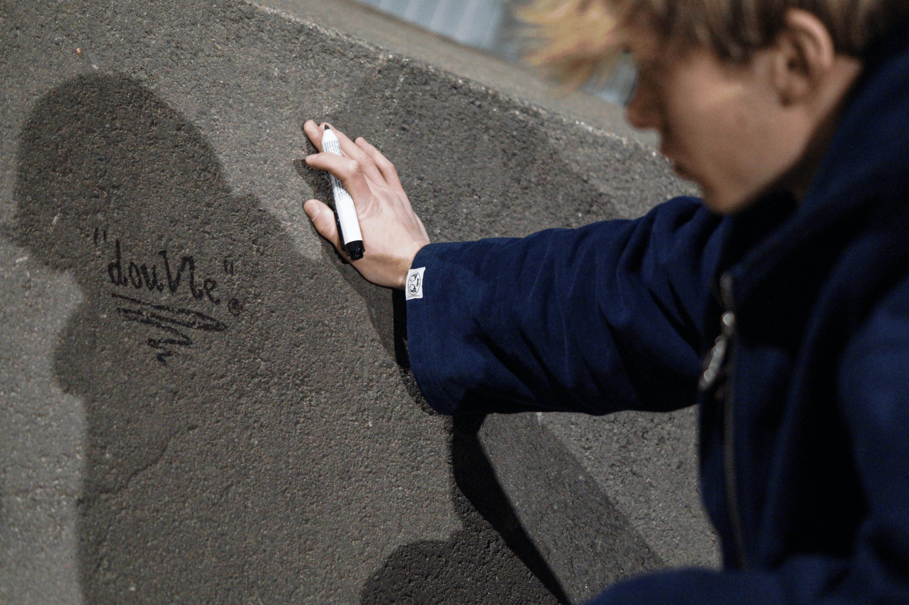 hand-painted douvle logo graffiti with guy who wears hoodie